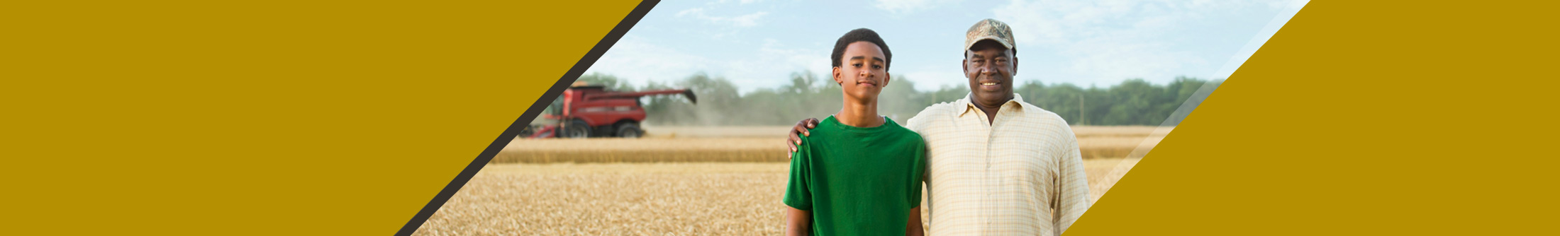 Farmer and son with equipment in wheat field
